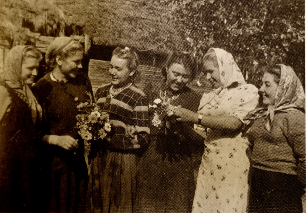 Photo of Roza with five other female snipers, including her friend Kali, wearing dresses and smiling