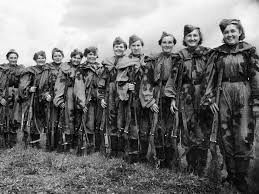 Photo of an entire female sniper platoon, in camoflauge, holding rifles, posing for the camera